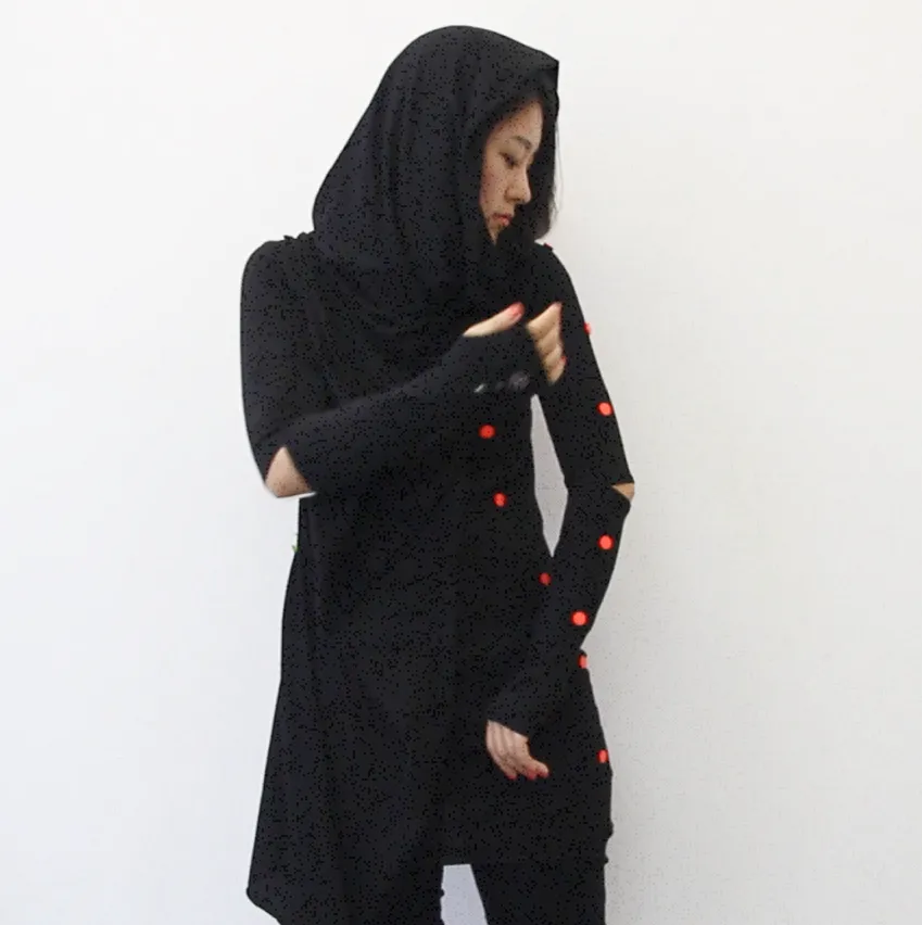 A woman wearing a black hoodie with RFID spots