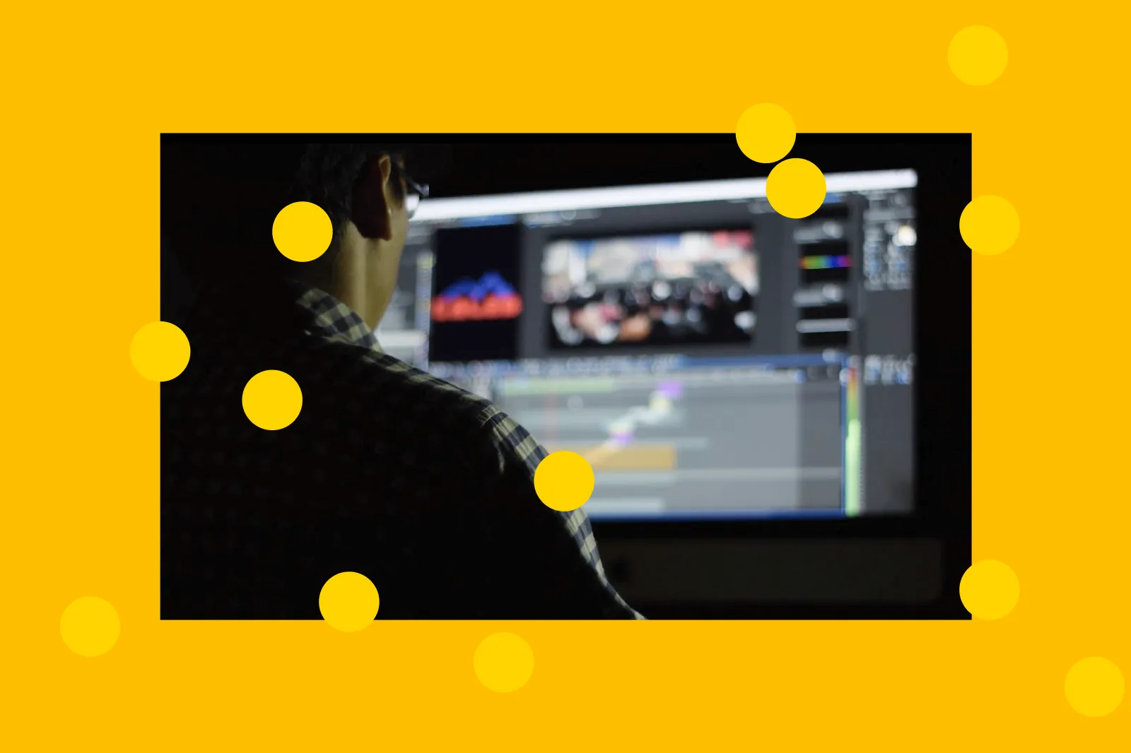 Video editor working on a computer, in yellow orange colored background