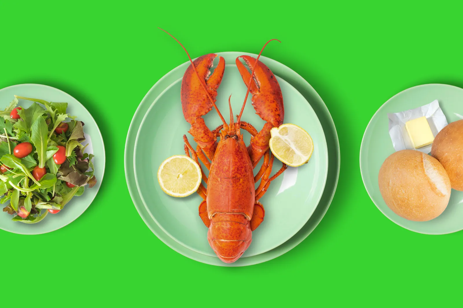 3 plates with food: Salad, lobster, dinner roll